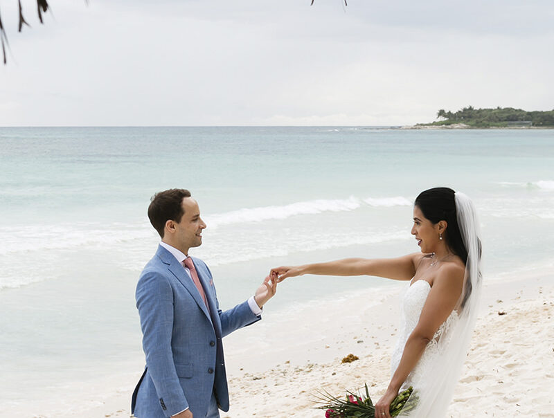 Just married couple holding hands on the beach during their destination wedding in the Riviera Maya