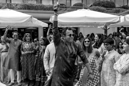 Guests joyfully lifting a participant during the Haldi ceremony in Rome, captured at Hotel Roma Life Style by Cossu Photography.