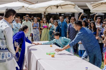 Guests joyfully lifting a participant during the Haldi ceremony in Rome, captured at Hotel Roma Life Style by Cossu Photography.