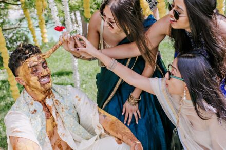 Hands covered in golden turmeric paste during the traditional Haldi ritual at Hotel Roma Life Style.