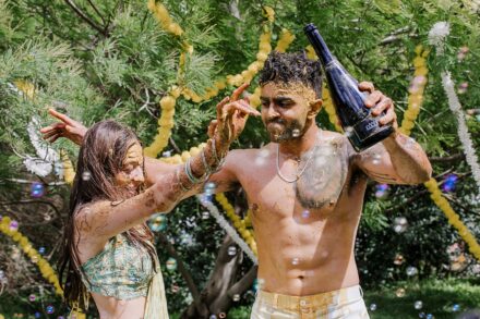 Reeya and Neil surrounded by friends and family, celebrating their Haldi in Rome with laughter and color.