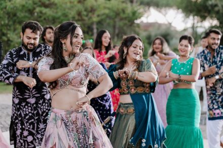 Family and friends performing traditional dances during the Sangeet celebration in Rome, captured by Cossu Photography.