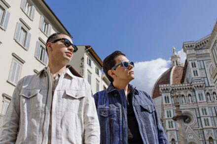 Lalo and Xavi walking hand in hand near the Florence Duomo during their pre-wedding photoshoot — elegant, cinematic and full of Tuscan light captured by Cossu Photography.