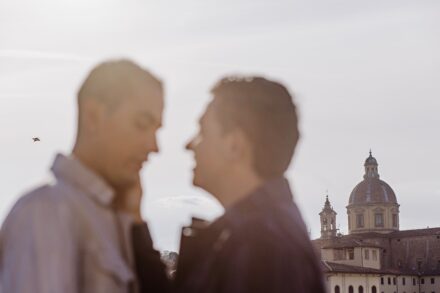 Lalo and Xavi embracing at sunset with the Tuscan skyline glowing behind them — romantic destination pre-wedding photography in Florence by Cossu Photography.