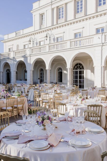 Elegant floral decorations and dinner setup for an Indian wedding at Villa Miani, Rome.