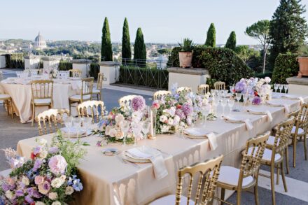 Romantic dinner setup with elegant floral decor at Villa Miani, Rome, during Reeya and Neil’s Indian wedding celebration.