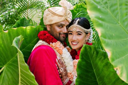 Indian bride and groom portrait surrounded by lush greenery during a luxury Hindu wedding in Tuscany, Italy