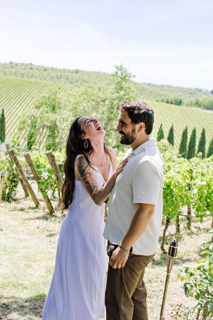 Dan and Sophie smiling at each other in the Chianti vineyards