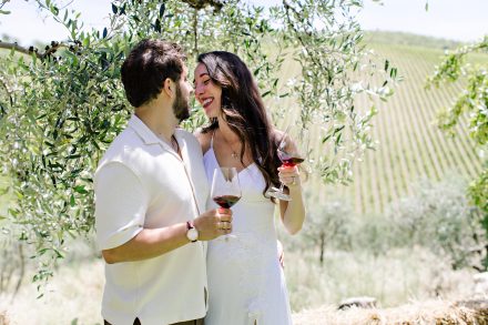 Newly engaged couple sharing a celebratory glass of wine